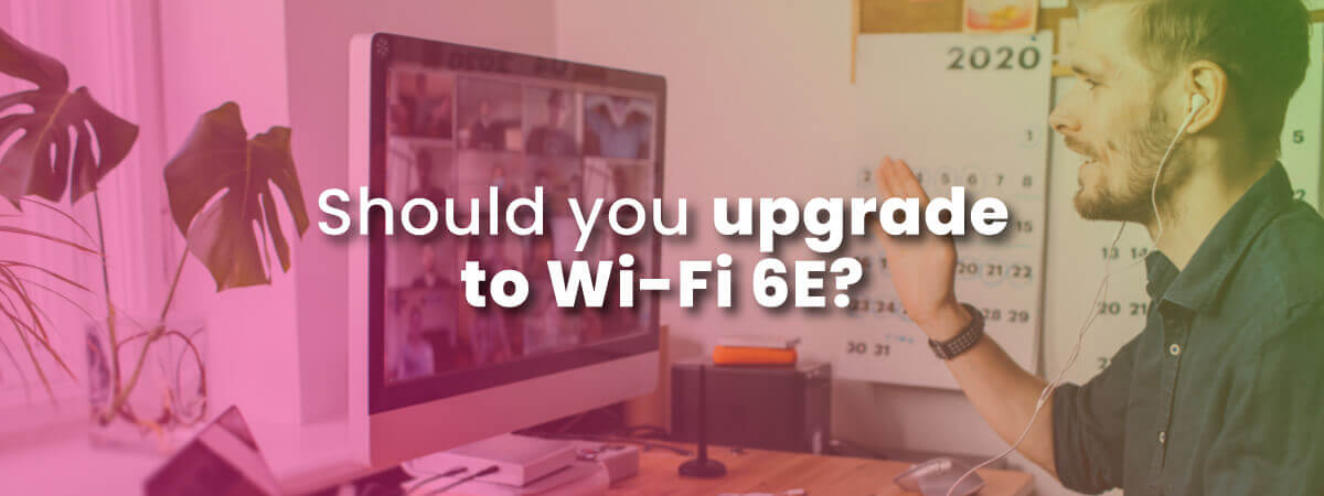 Should you upgrade to Wi-Fi 6E with image of smiling man using laptop