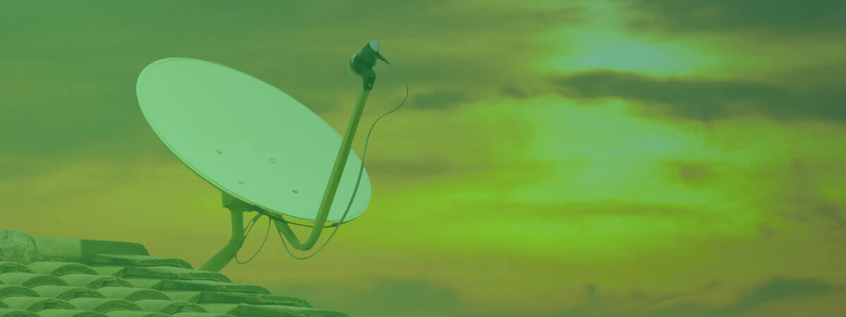 Image of satellite dish against a sunrise to show how satellite tv works