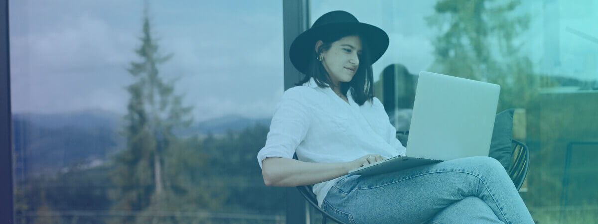 a young woman uses her digital device to connect to the internet from her porch