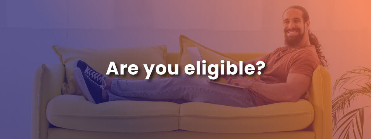 Are you eligible? with image of happy long-haired man using the internet at home