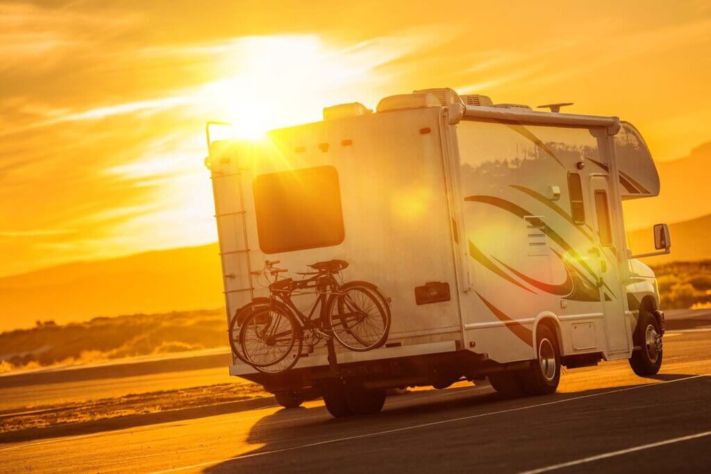 an rv driving into the sunset