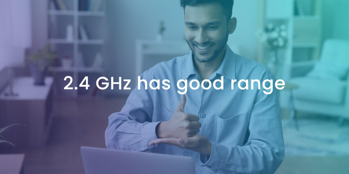 2.4 GHz has better range for your home Wi-Fi with image of man smiling and computer and mobile device