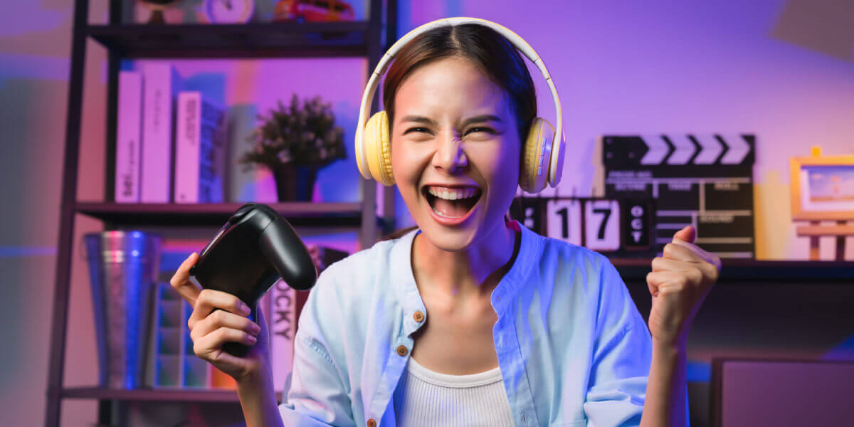 image of smiling girl playing online games with gaming controller