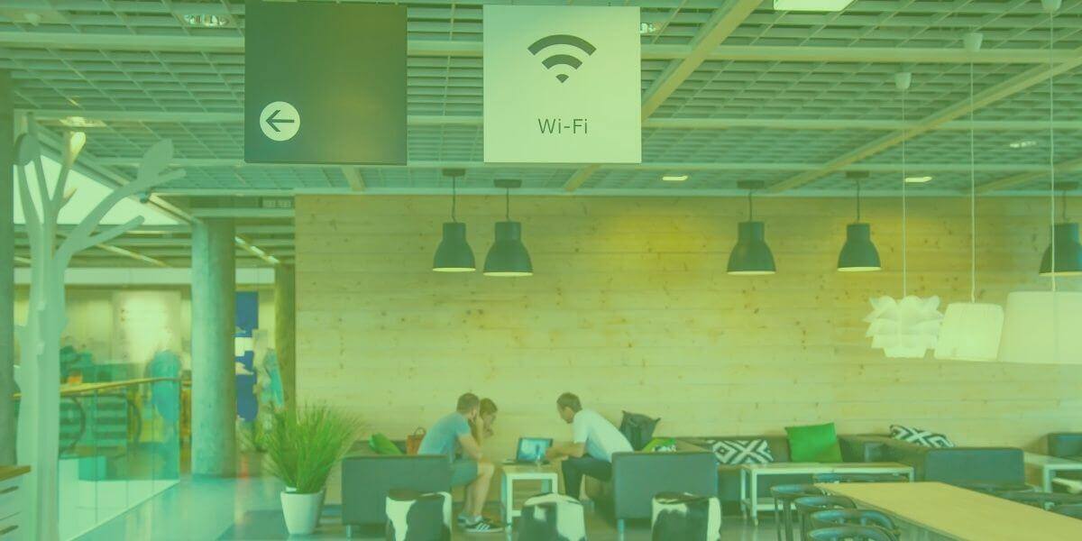 Long shot of a cafe with a public Wi-Fi banner hanging from rafters