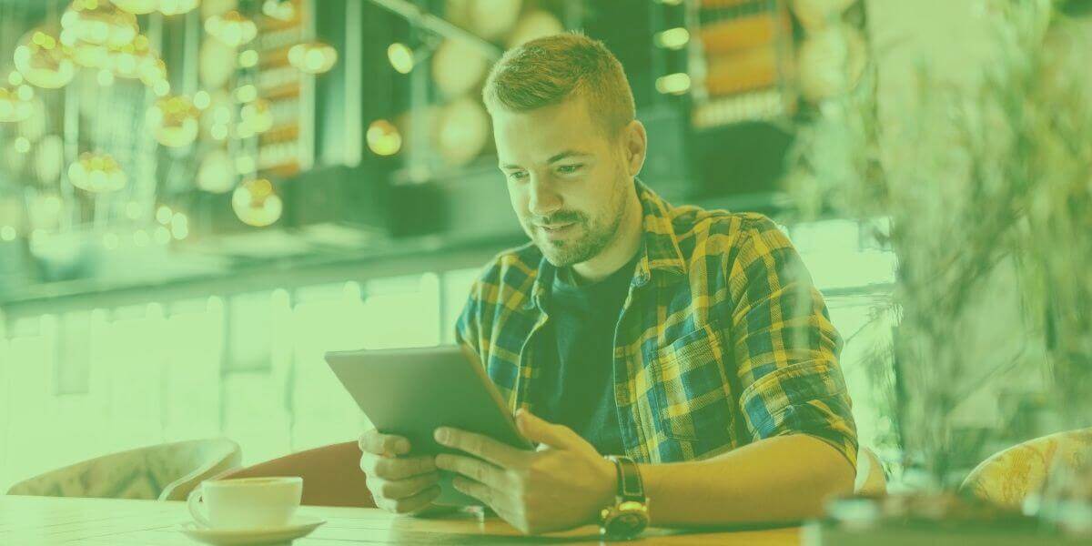 Man in library entering Wi-Fi password on device