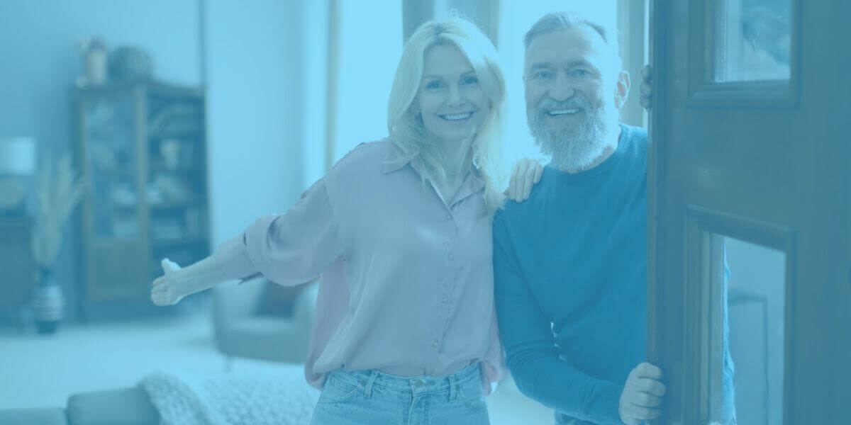 Mature couple opens door of their home