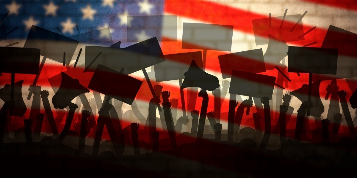 Shadoy people protesting with signs in front of an American flag