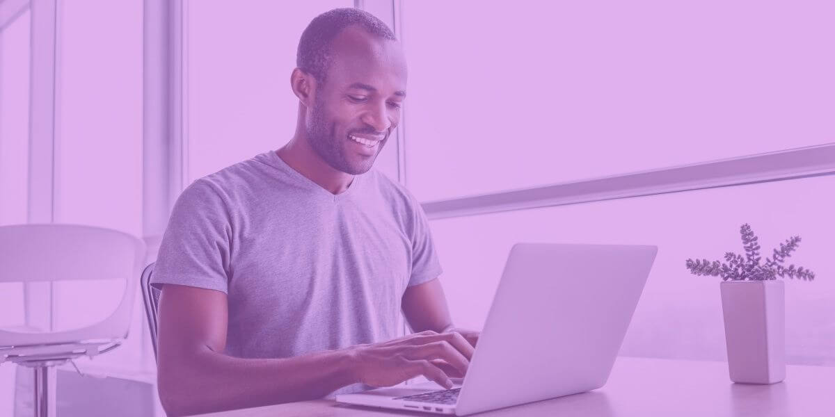 Smiling man uses fast Cable internet on his laptop at home