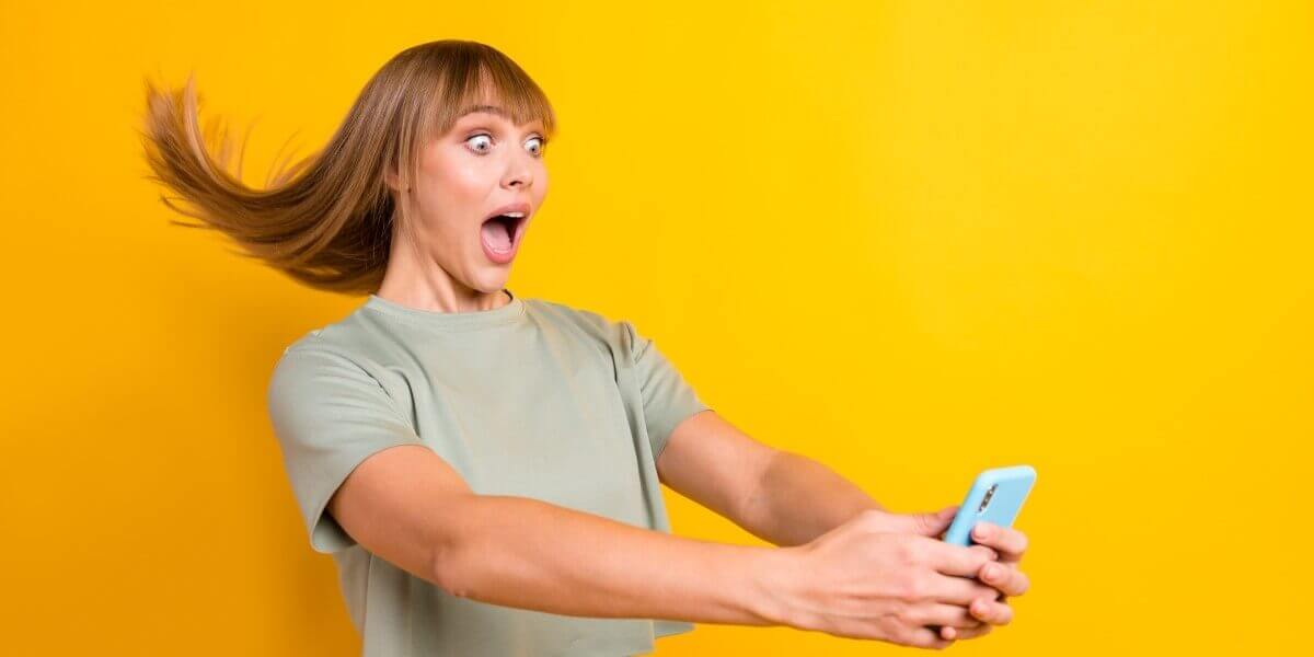 Woman's hair blows back from her cell phone due to gigabit speed