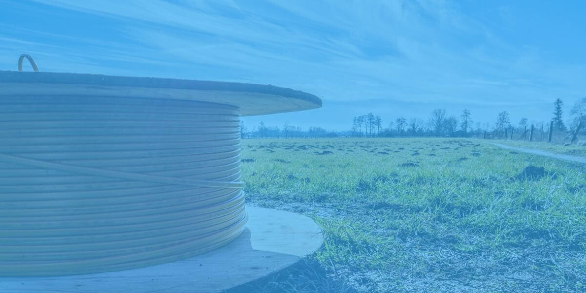 Roll of fiber-optic line sitting in a rural field