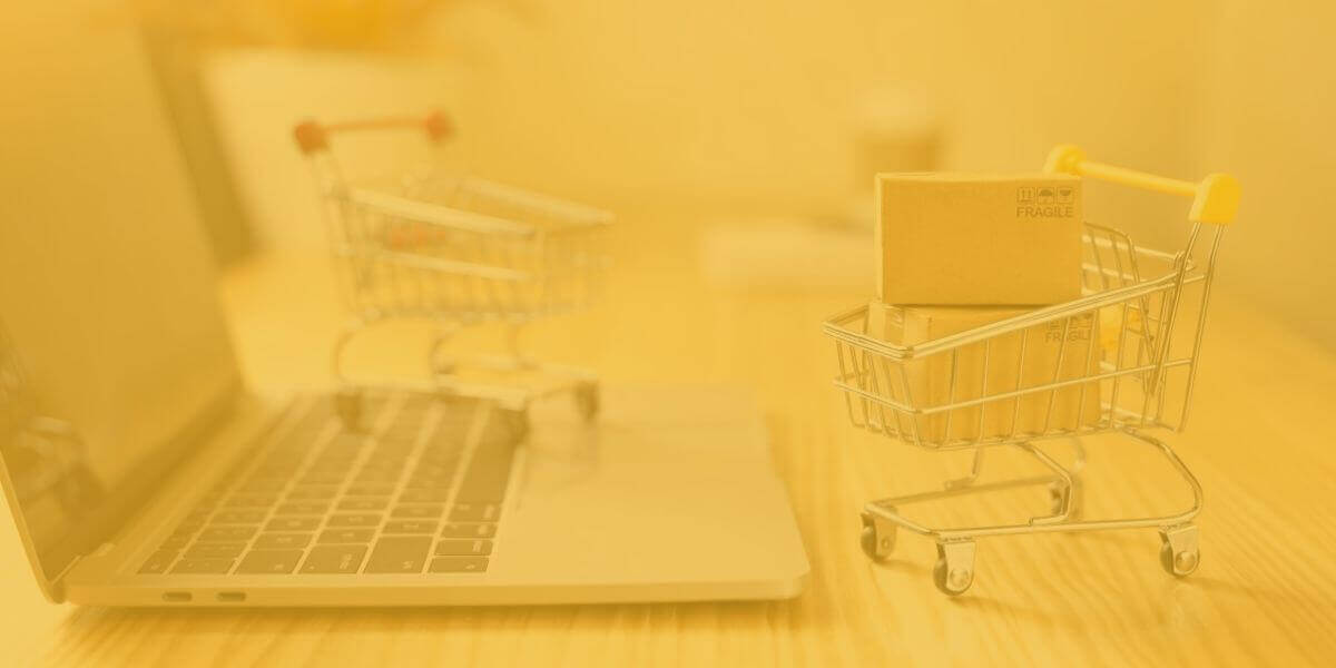 tiny grocery carts sit on laptop keyboard