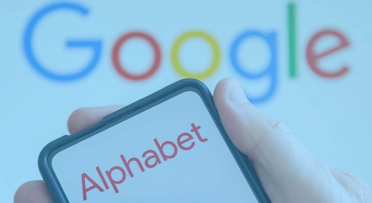 smart phone displaying Alphabet logo in front of screen with Google logo