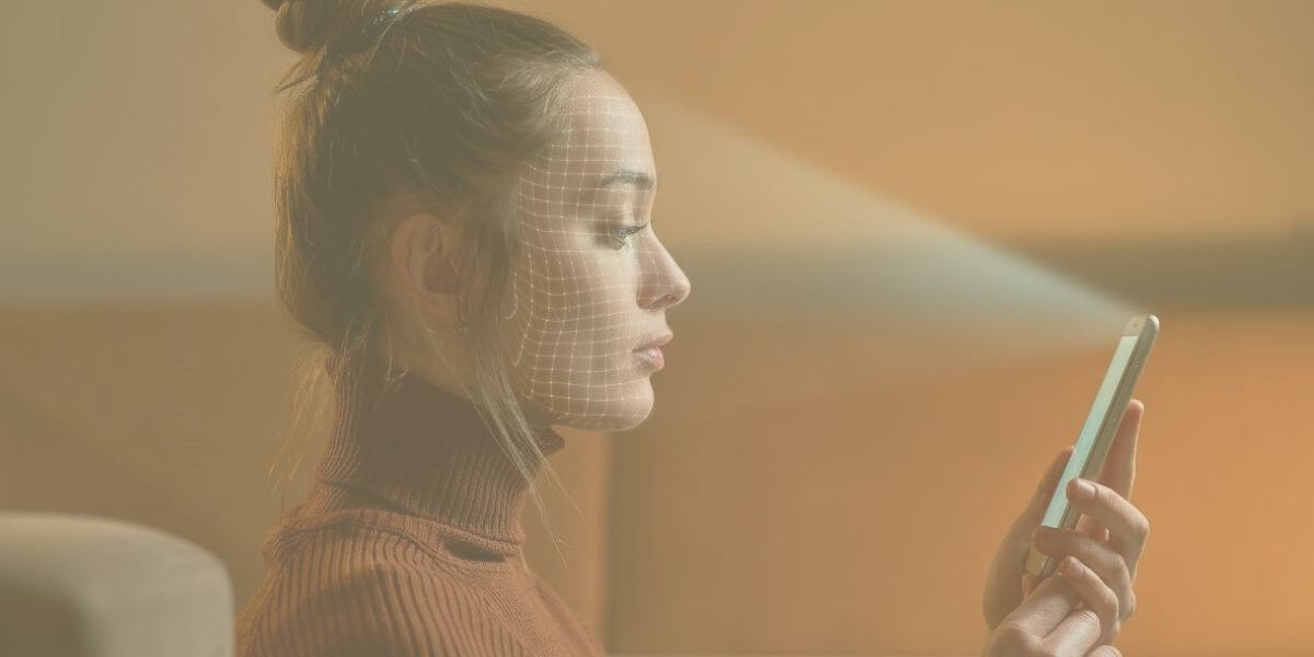 a woman looks at a a tablet that is scanning her face