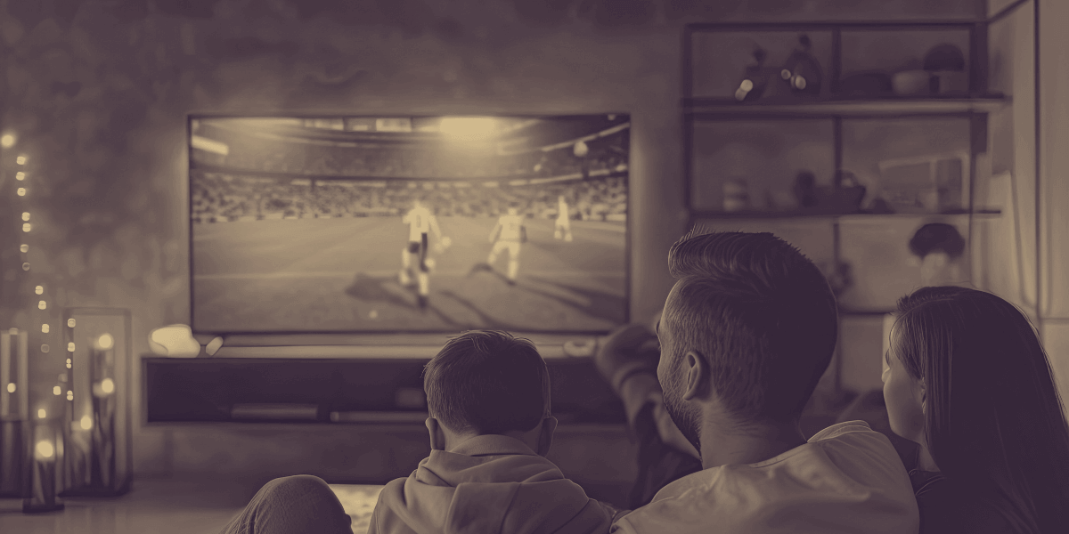 Family watching soccer on TV