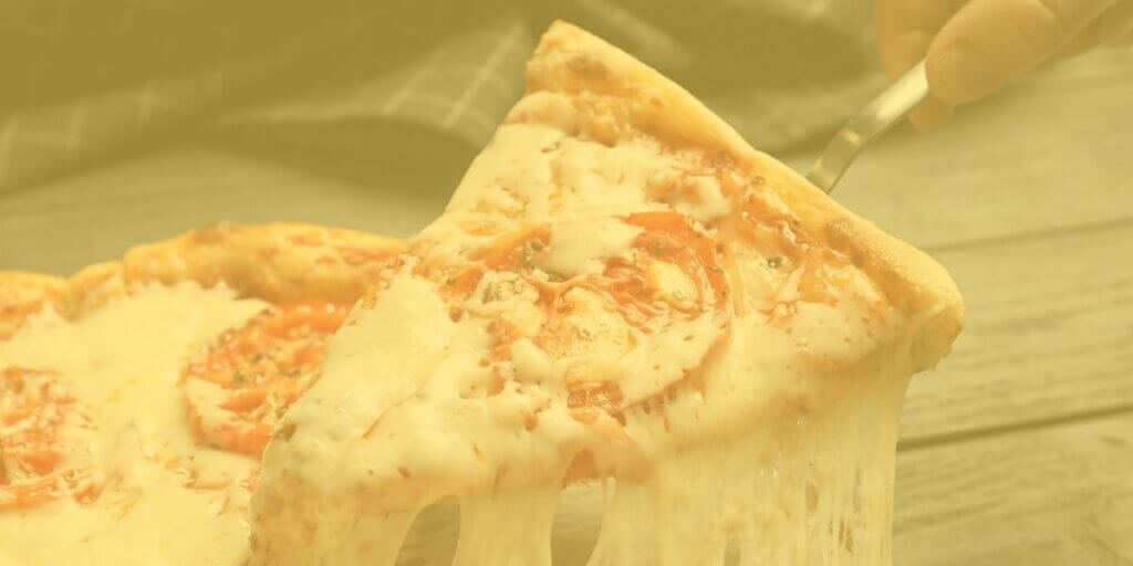 slice of pizza with cheese stretching to plate