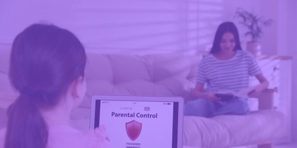 Girl uses laptop with parental controls while sitting with mother in living room