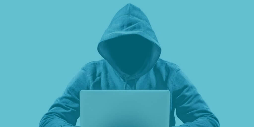 hooded hacker prepares to commit cybercrime