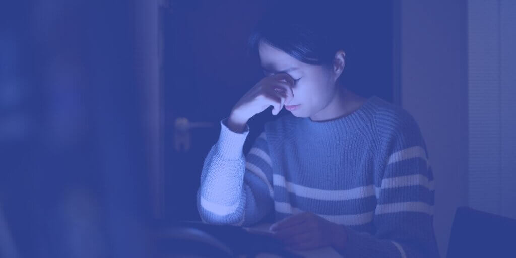 Woman looks frustrated with her slow internet on her tablet