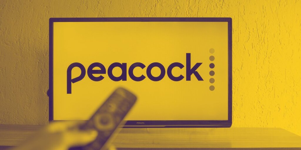 remote control in front of TV with Peacock logo