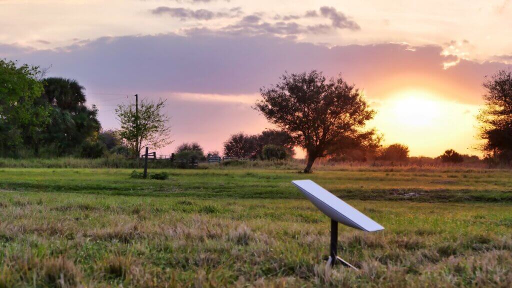 Starlink standard size satellite internet dish in field