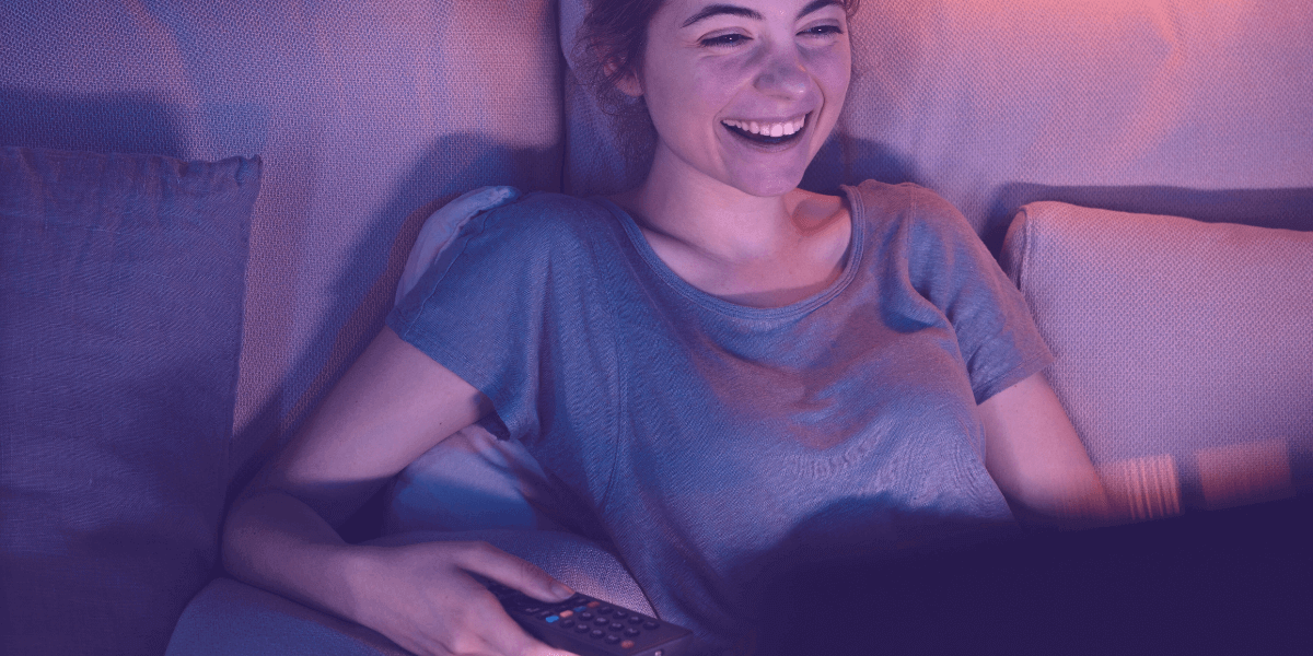 Girl smiling while watching TV