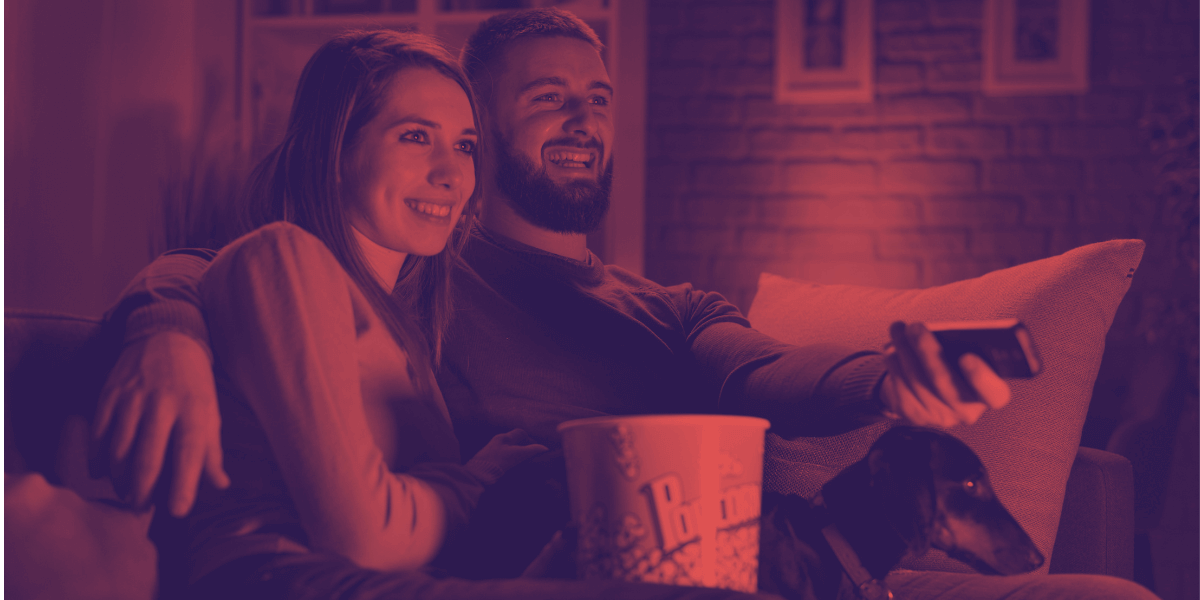 Pareja viendo televisión con palomitas de maíz