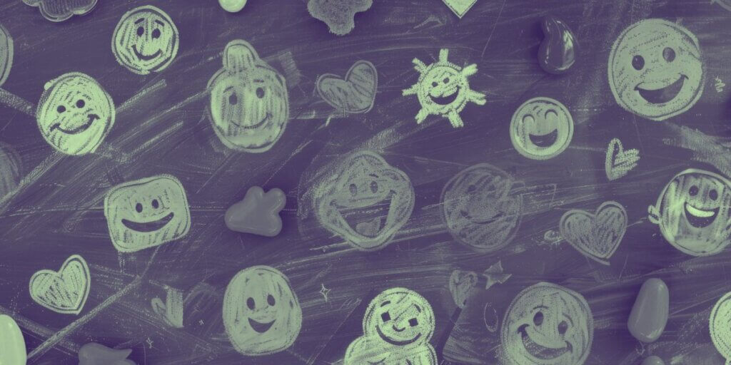 emojis drawn in chalk on a blackboard