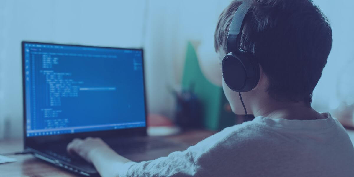 Young boy using his laptop to learn how to code