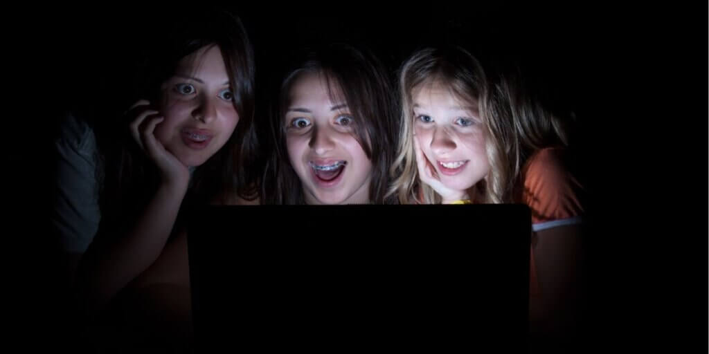 girls having fun on the internet at slumber party