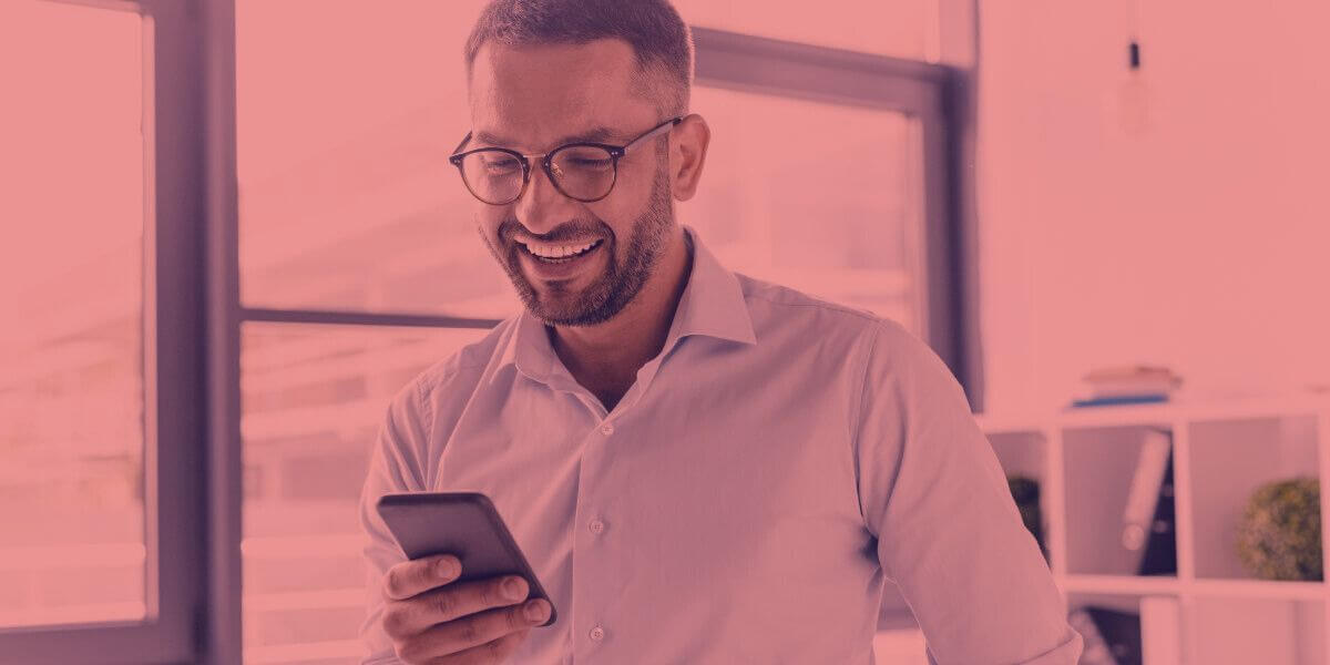 Man smiling using a smartphone