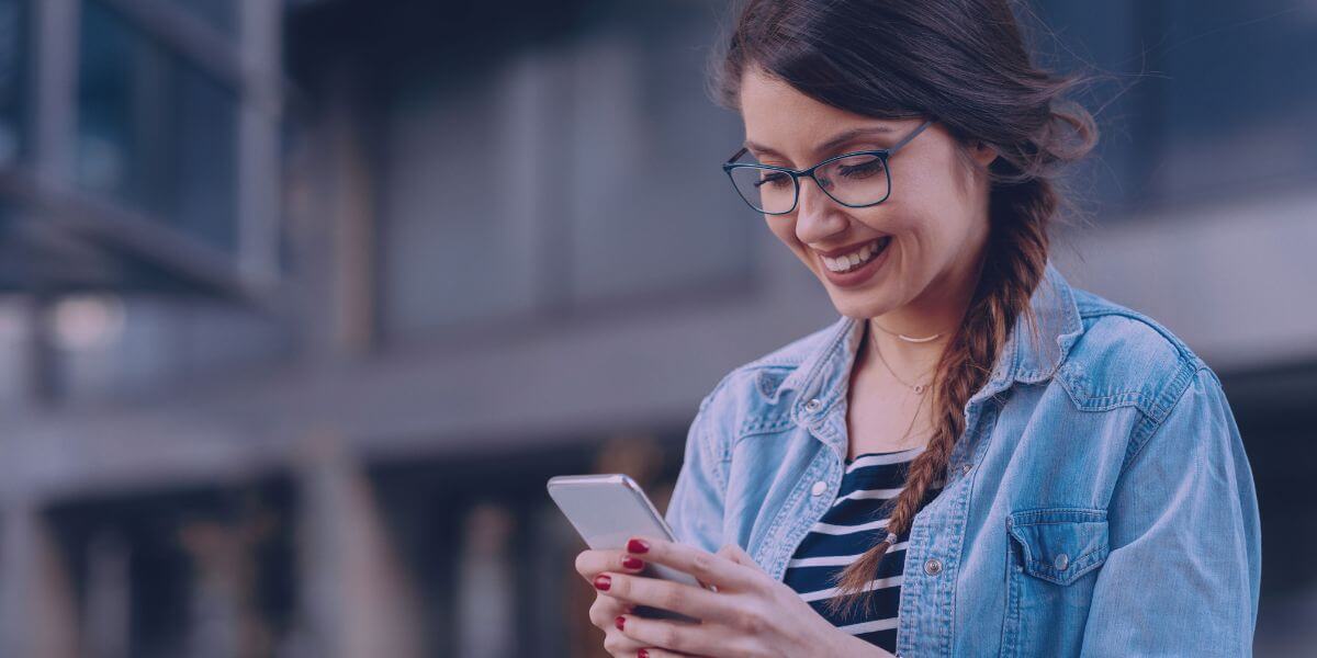 young woman smiling at phone