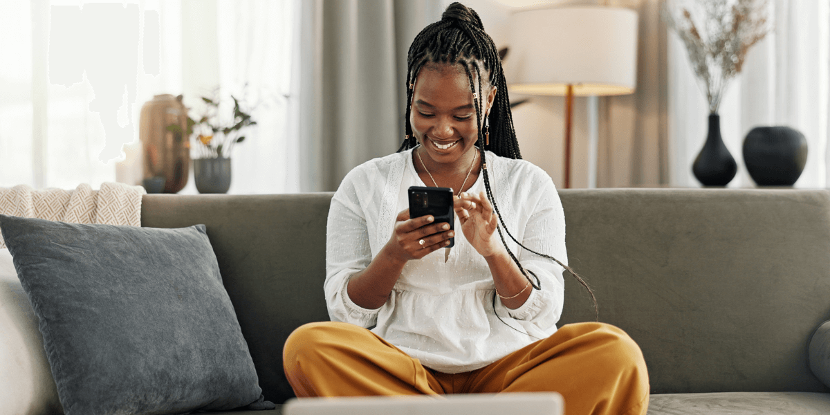 Smiling young woman looking at her phone