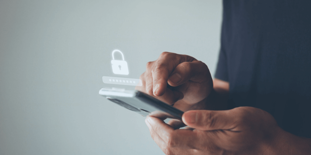 Person typing in a password on a phone