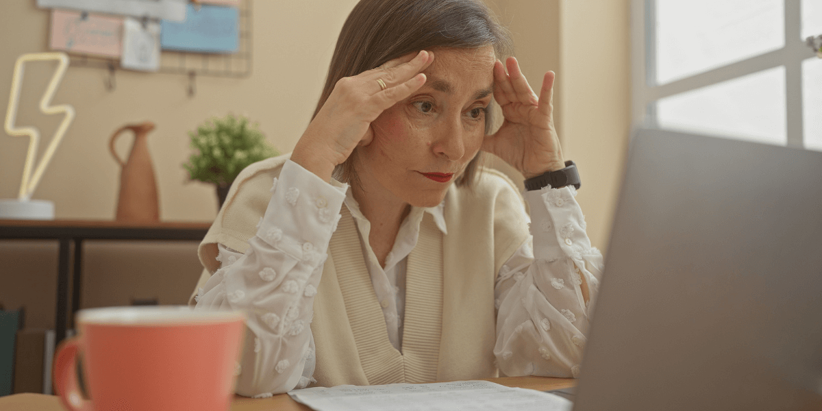 Woman looking at computer with a frustrated face