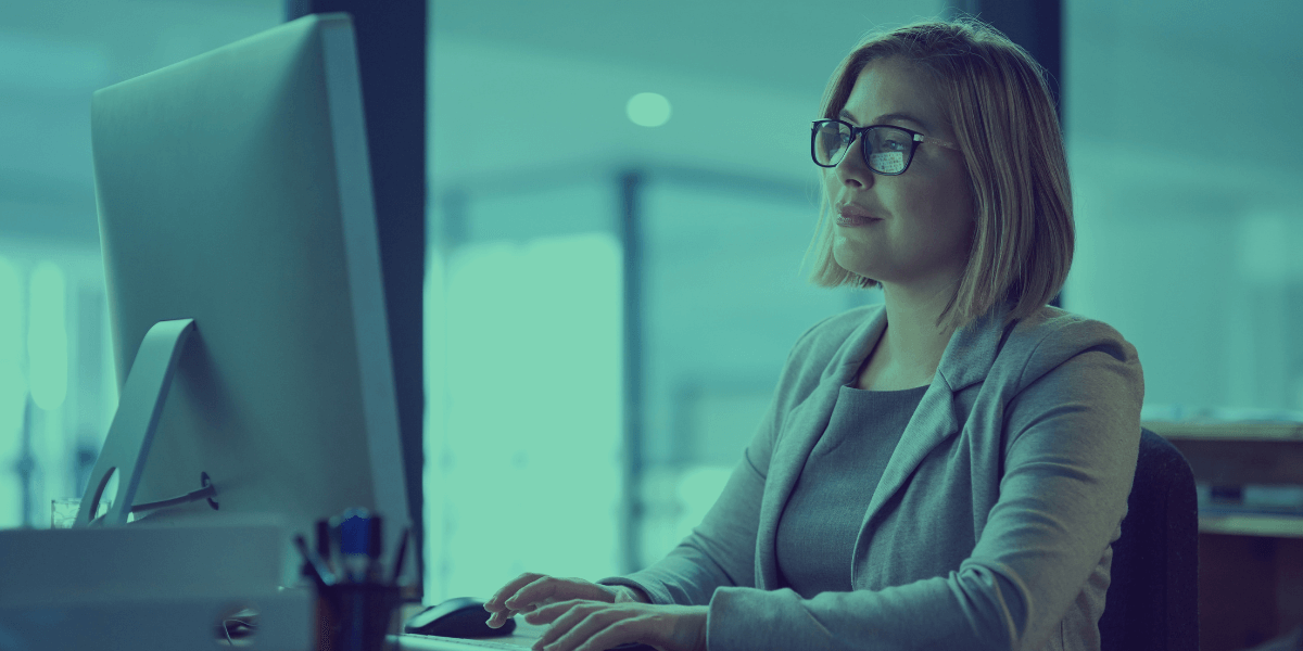 woman in a suit working on computer