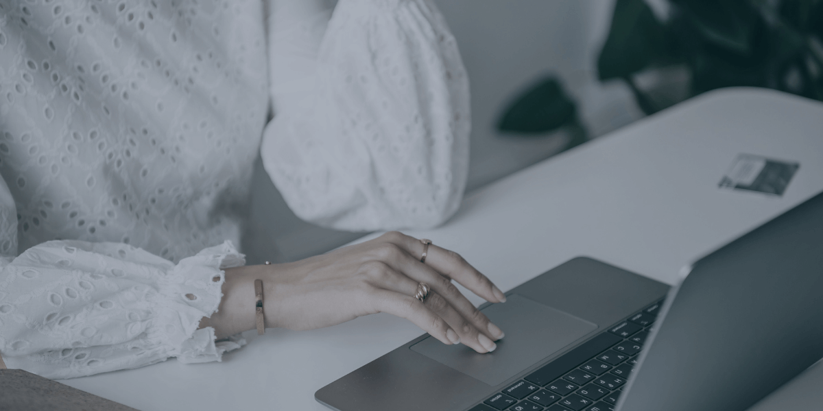 woman's hands working on a laptop