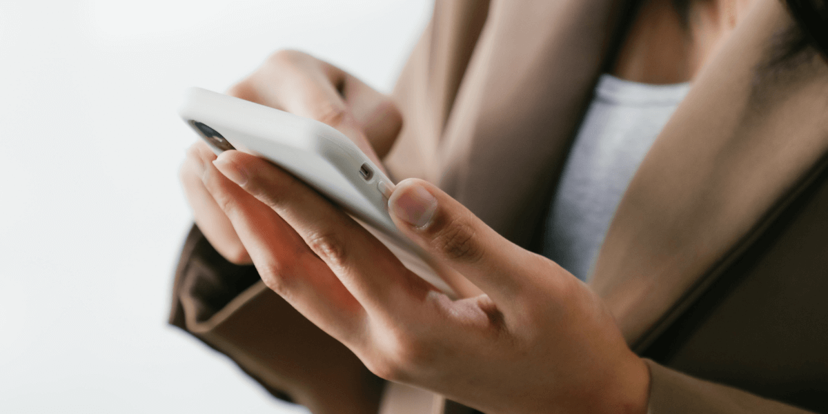 Person typing on a smart phone