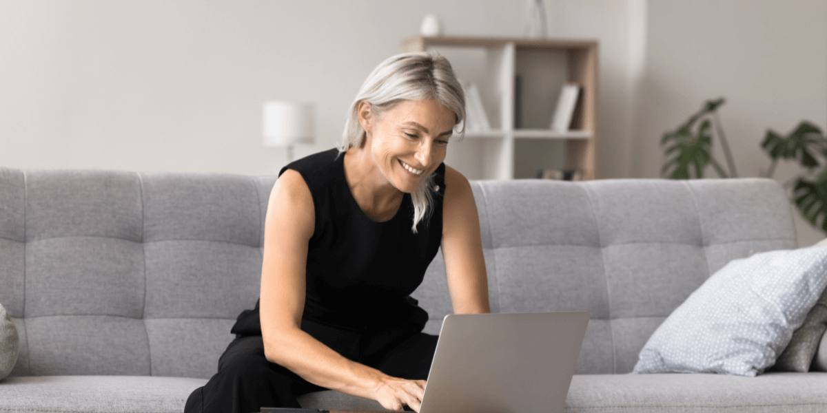 Older woman typing on a laptop