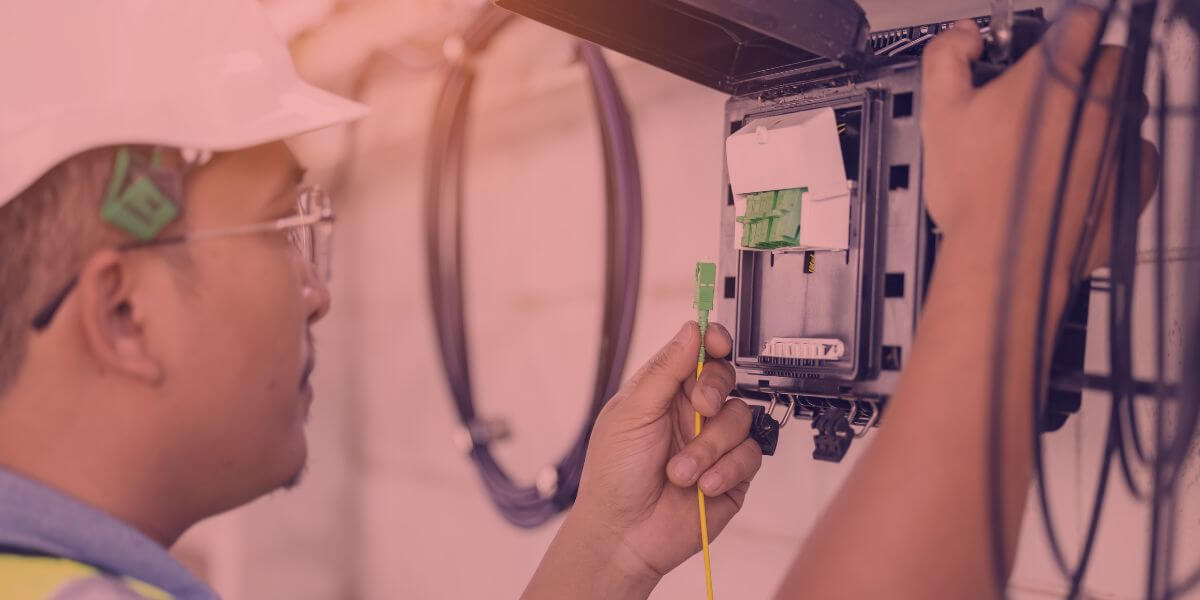 worker installing network cable