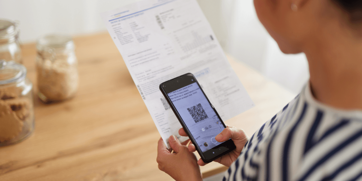 person scanning a qr code on a bill