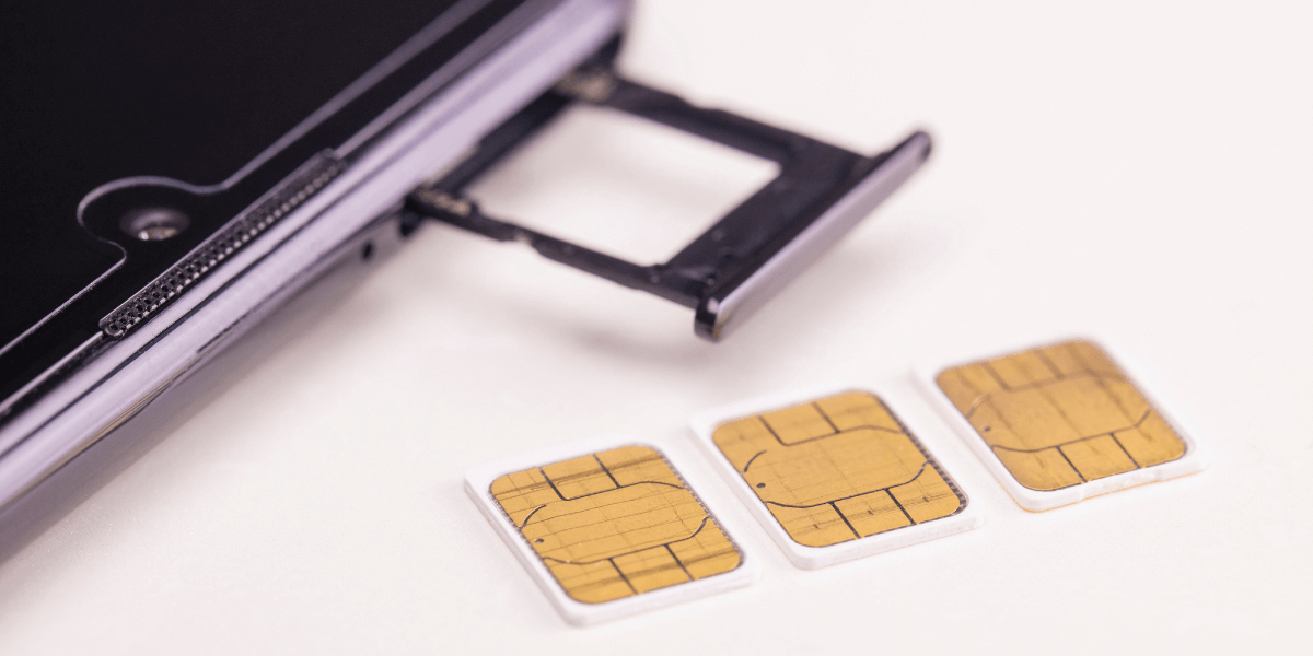 Phone with sim cards laying next to it
