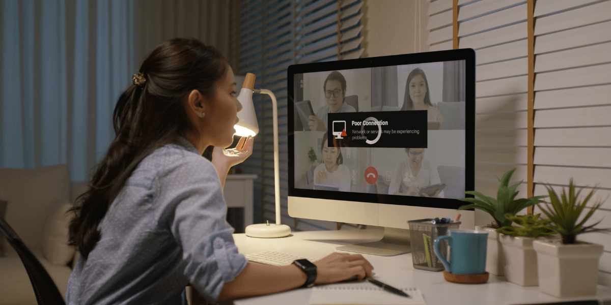 Woman looking at computer with a buffering screen