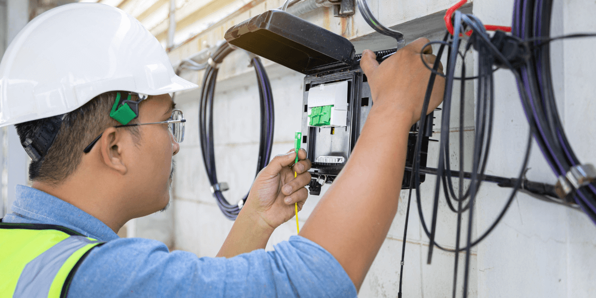 man installing fiber internet to a home