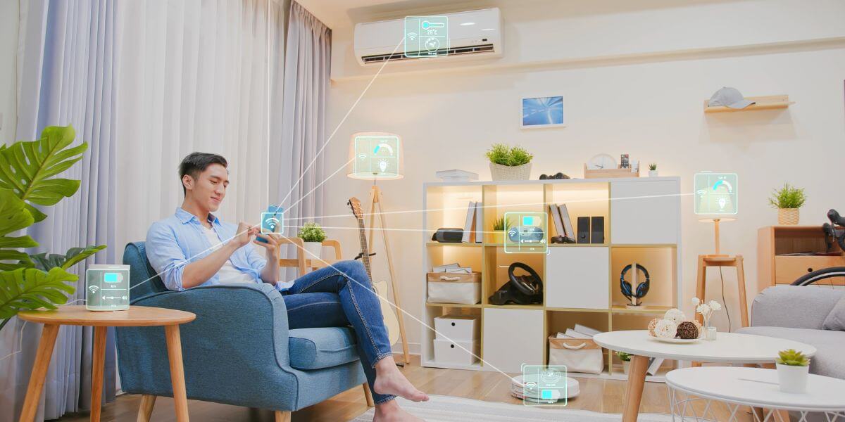 person on chair using phone connected to other devices