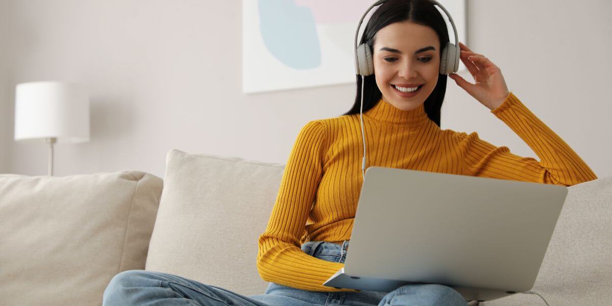 woman with headphones using laptop