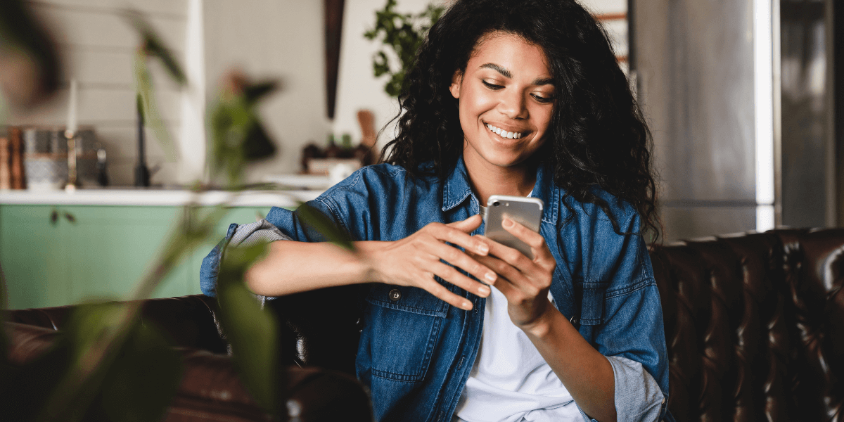woman smiling using phone