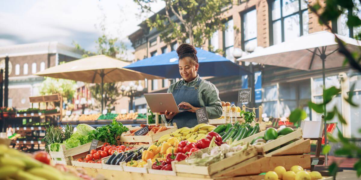 woman with laptop in outdoor market