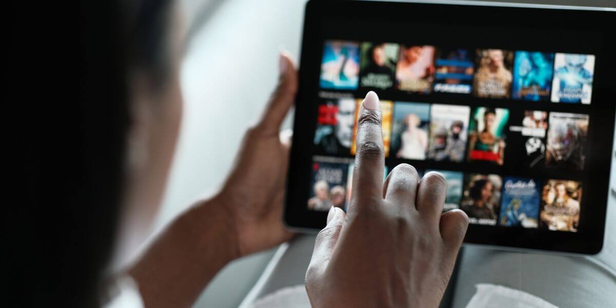 person using tablet oto watch movies