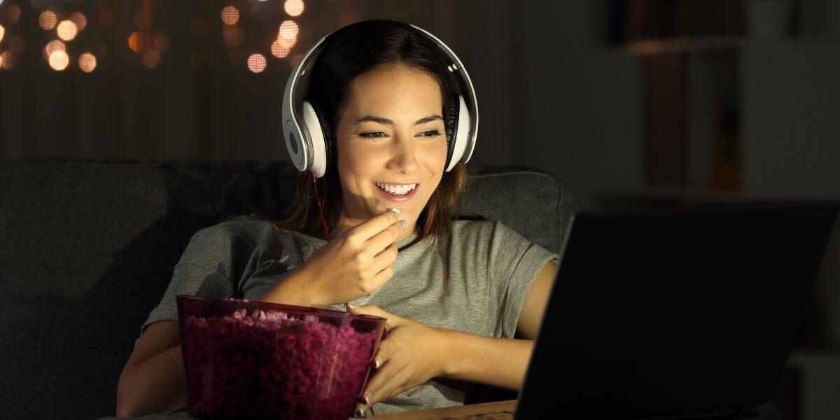 woman smiling eating popcorn