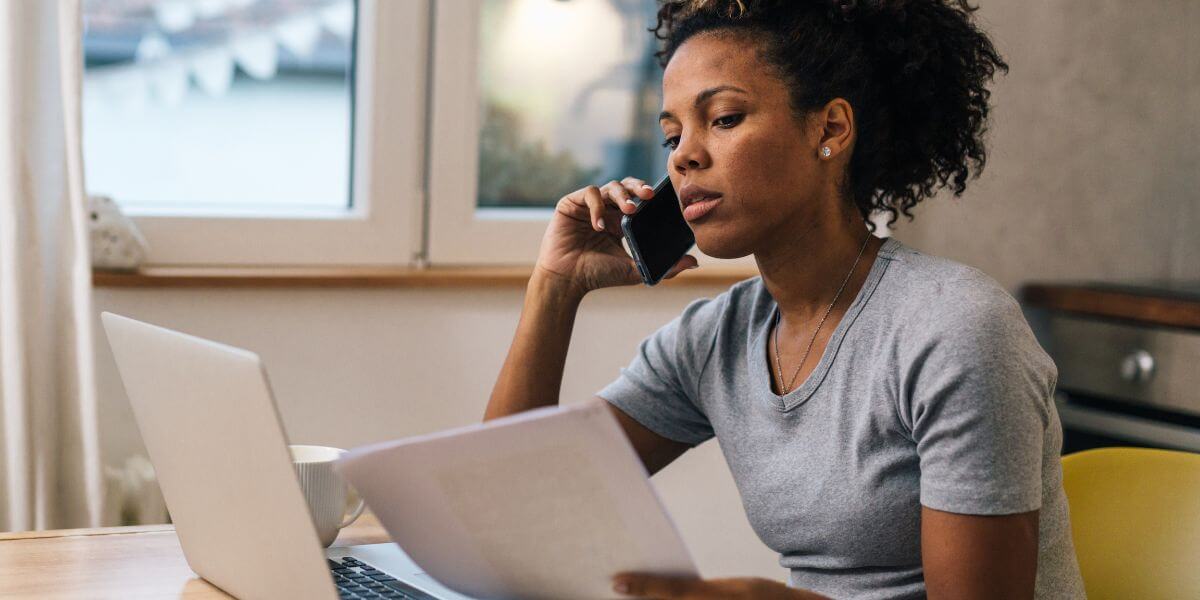 Internet bill negotiation woman on phone with laptop
